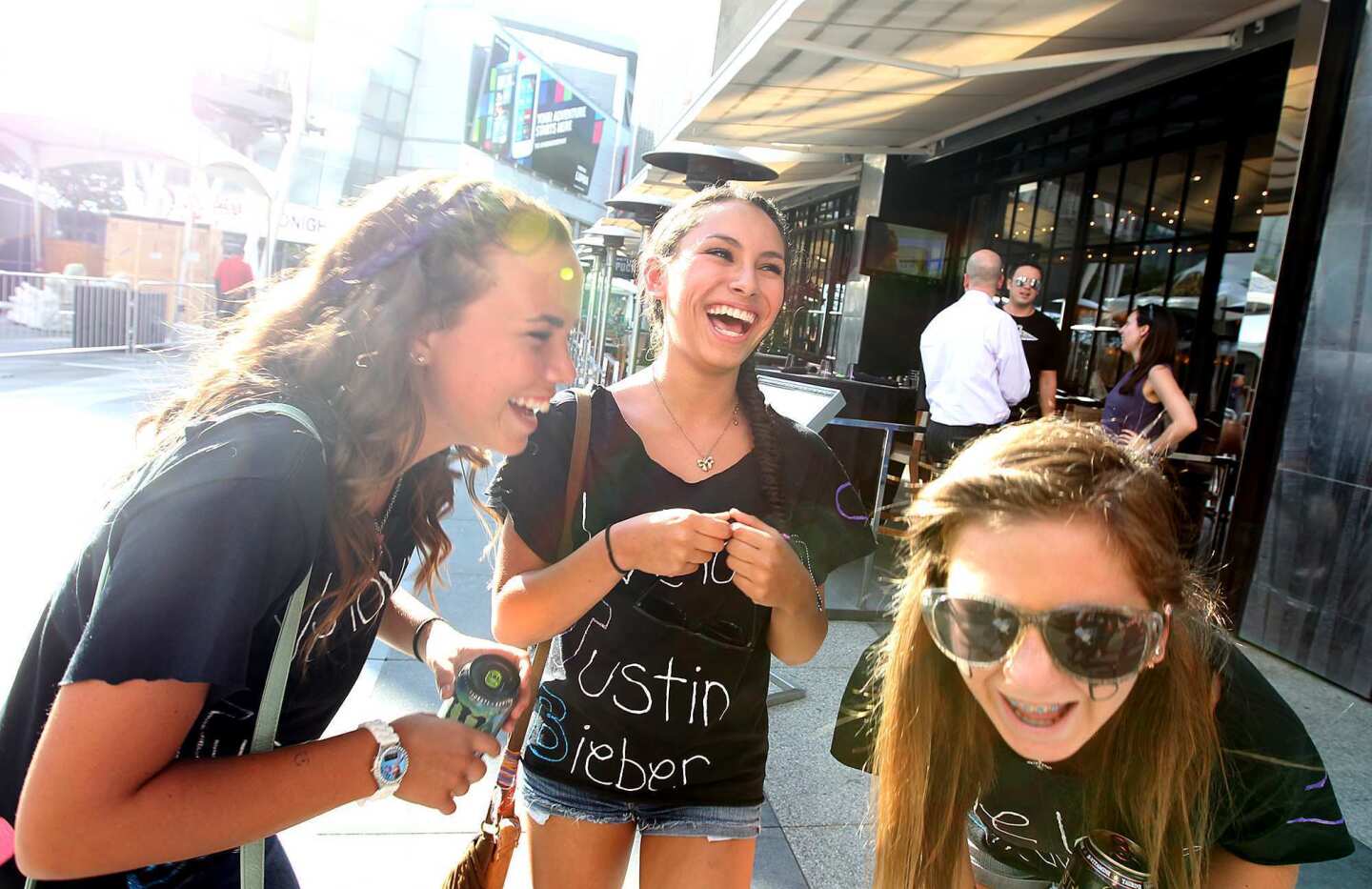 Emily Swarthout, Danniella Dupone and Jordan Davies, all 13 and from San Diego, giggle over Justin Bieber in their homemade T-shirts before the first of his two concerts at Staples Center.