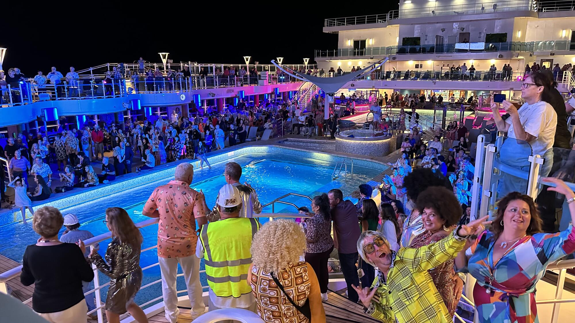 A disco party around a pool on a cruise ship.  