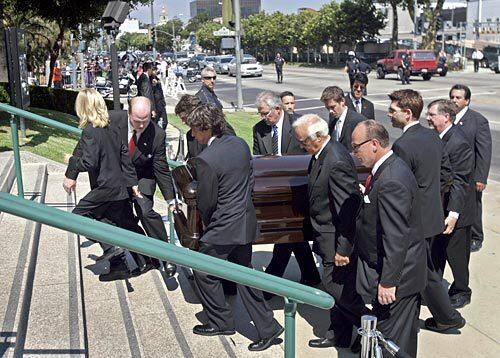 Pallbearers carry the casket of Merv Griffin into Church of the Good Shepherd in Beverly Hills. The entertainer and TV mogul died Sunday at age 82.