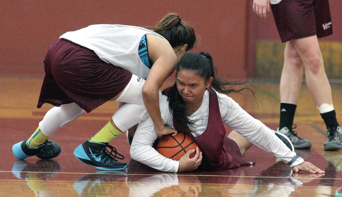 Maria Quejada, right, battles on the floor for the ball against teammate Deanna Gordillo at a Glendale Community College women's basketball practice on Monday, Nov. 9, 2015.