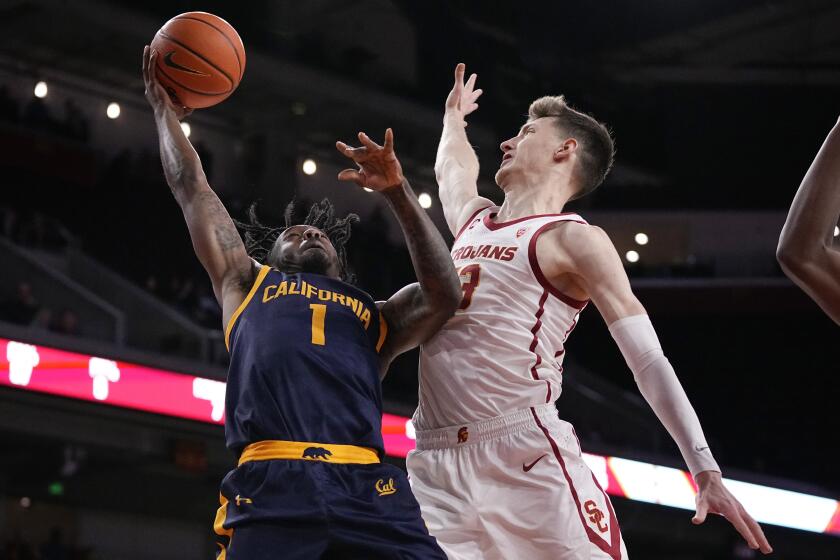 California guard Joel Brown, left, shoots as Southern California guard Drew Peterson defends during the first half of an NCAA college basketball game Thursday, Feb. 16, 2023, in Los Angeles. (AP Photo/Mark J. Terrill)