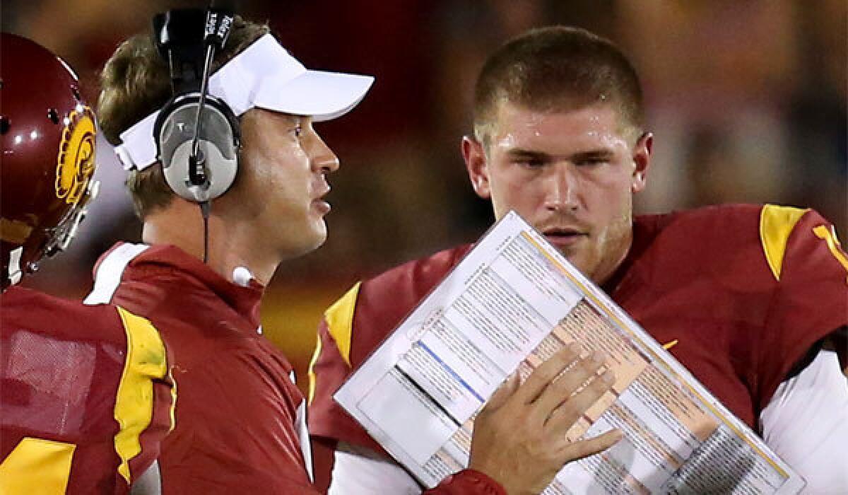 Then-USC coach Lane Kiffin talks with quarterback Max Wittek during a timeout against Washington State on Sept. 7.
