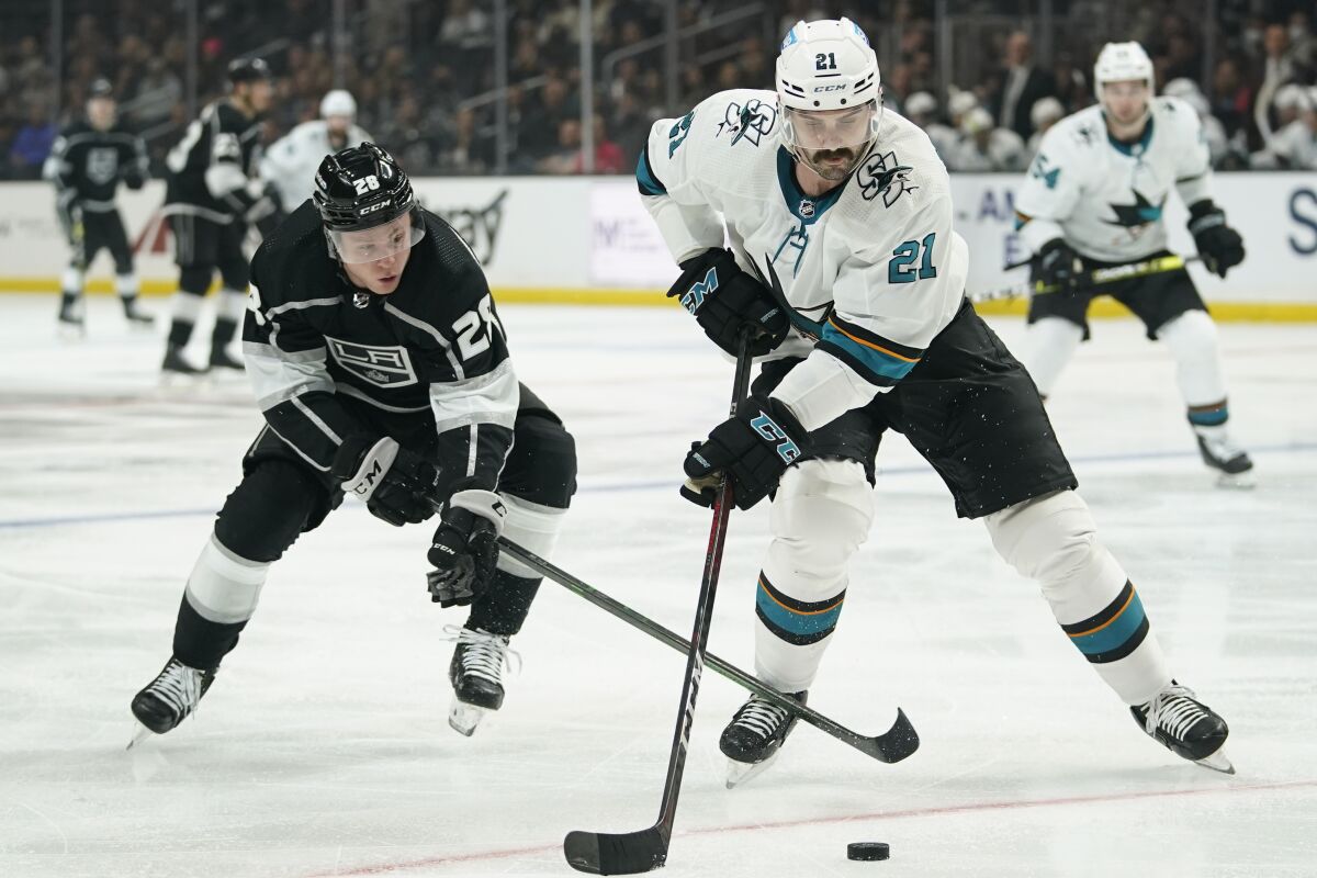 San Jose Sharks defenseman Jacob Middleton controls the puck against Kings center Jaret Anderson-Dolan.