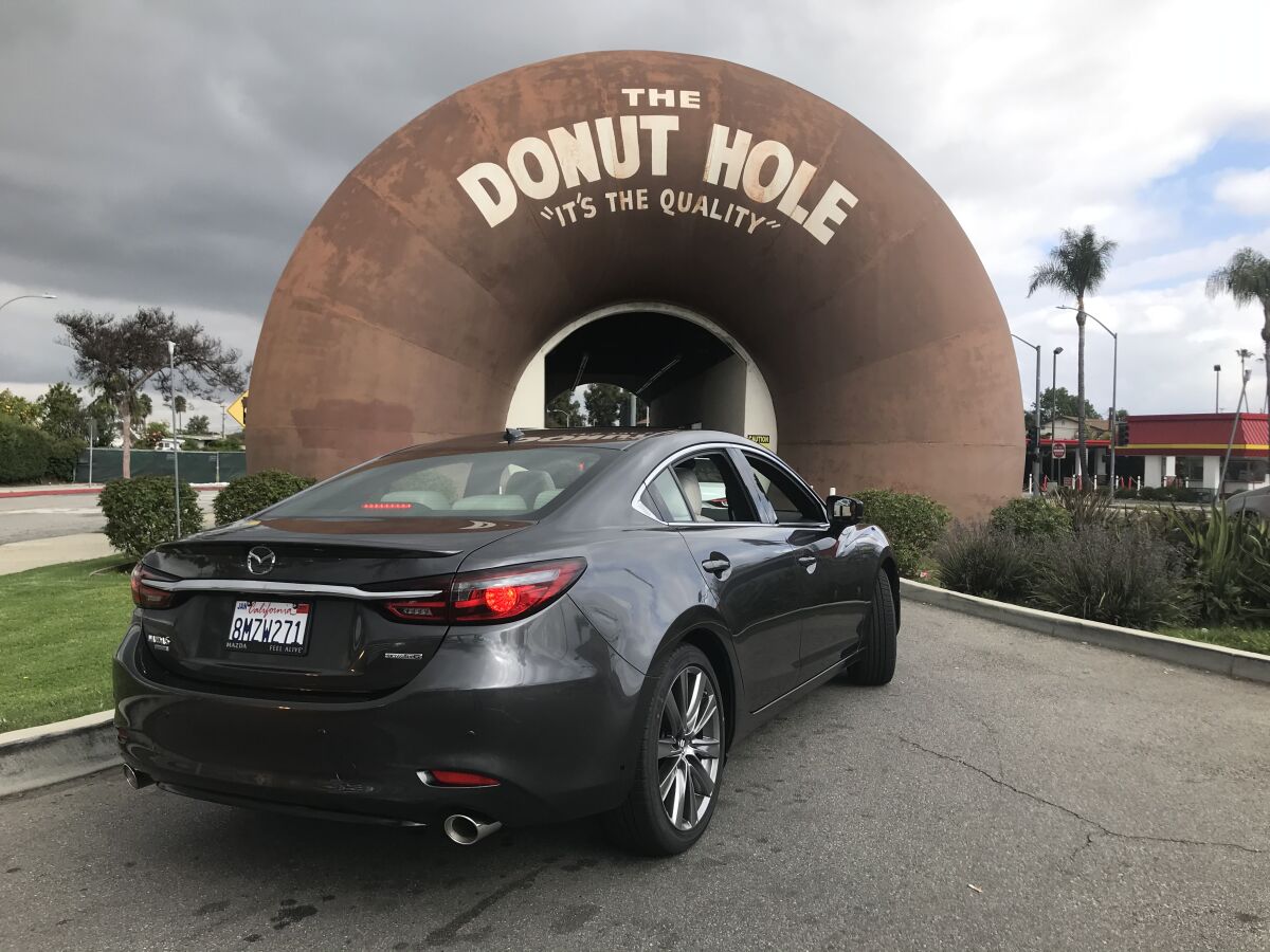 Cars drive through a line at the Donut Hole in La Puente.