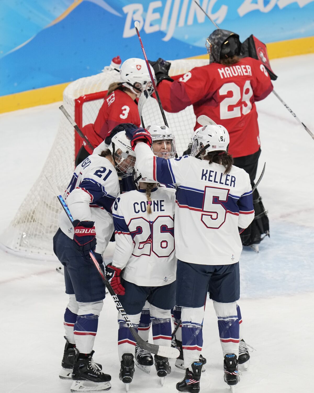 United States' Hilary Knight (21) is congratulated after scoring a goal against Switzerland goalkeeper Saskia Maurer (29) during a preliminary round women's hockey game at the 2022 Winter Olympics, Sunday, Feb. 6, 2022, in Beijing. (AP Photo/Petr David Josek)