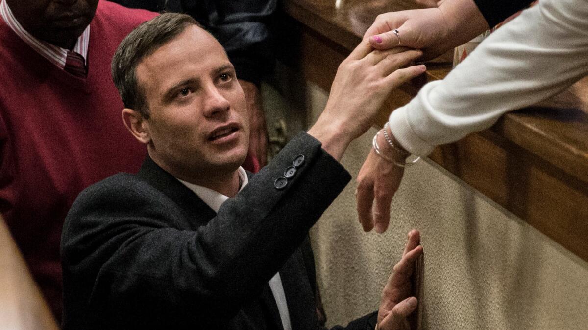 Oscar Pistorius leaves the courtroom Wednesday after his prison sentence was announced.