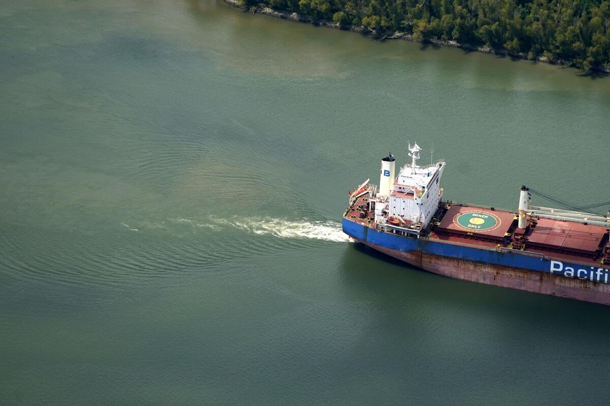 Aerial photo shows sediment in the Mississippi River as a tanker ship moves upriver.