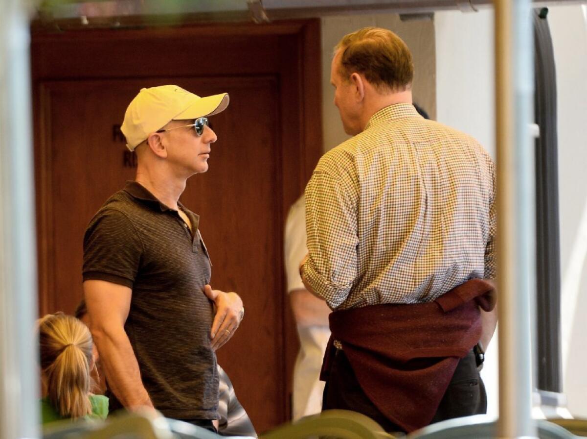 Amazon CEO Jeff Bezos, left, talks with Donald Graham, chairman and CEO of Washington Post Co., at the Allen and Co. Media and Technology Conference in Sun Valley, Idaho, last month.
