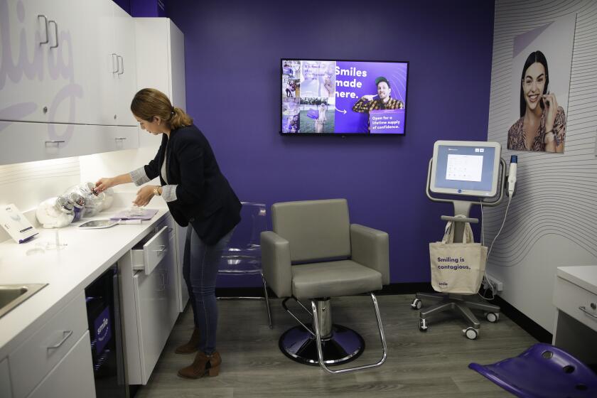 FILE - In this April 24, 2019, file photo dental assistant Jessica Buendia works in SmileDirectClub's SmileShop located inside a CVS store in Downey, Calif. CVS Health reports financial results Wednesday, May 1. (AP Photo/Jae C. Hong, File)