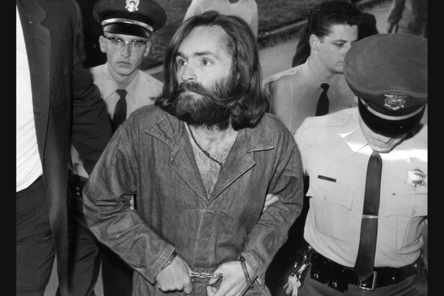 Charles Manson is escorted to court for preliminary hearing in 1969.