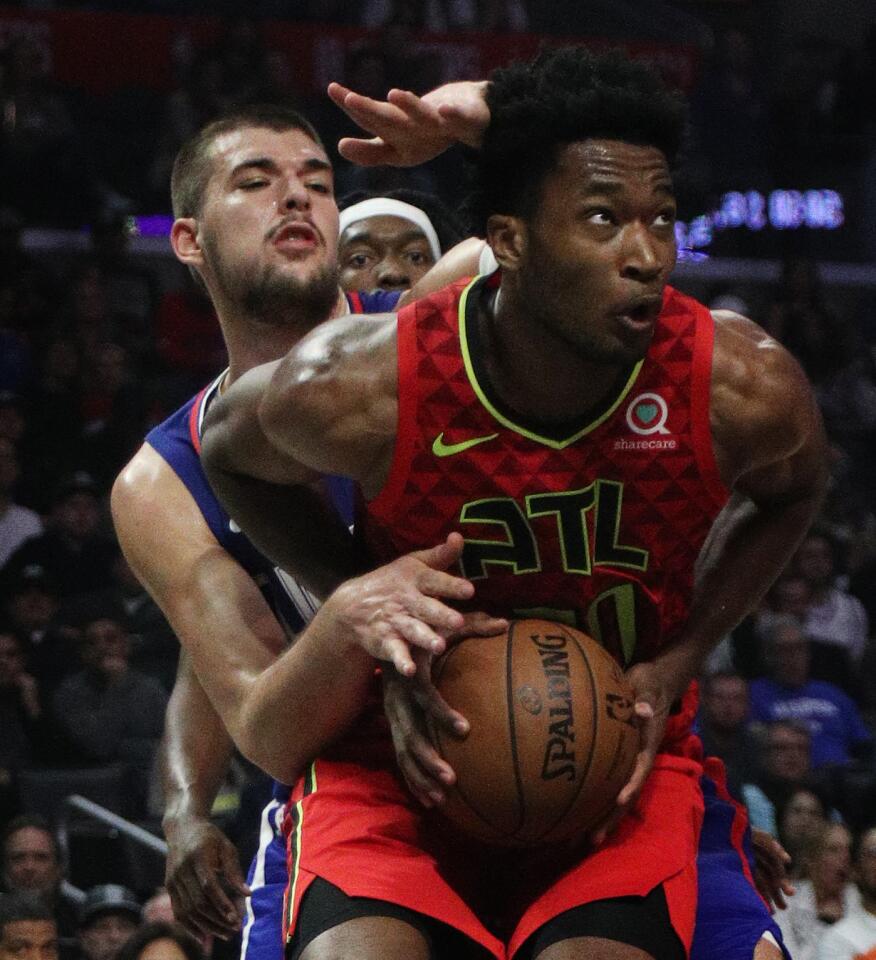 Clippers center Ivica Zubac, right, pressures Atlanta Hawks center Damian Jones.