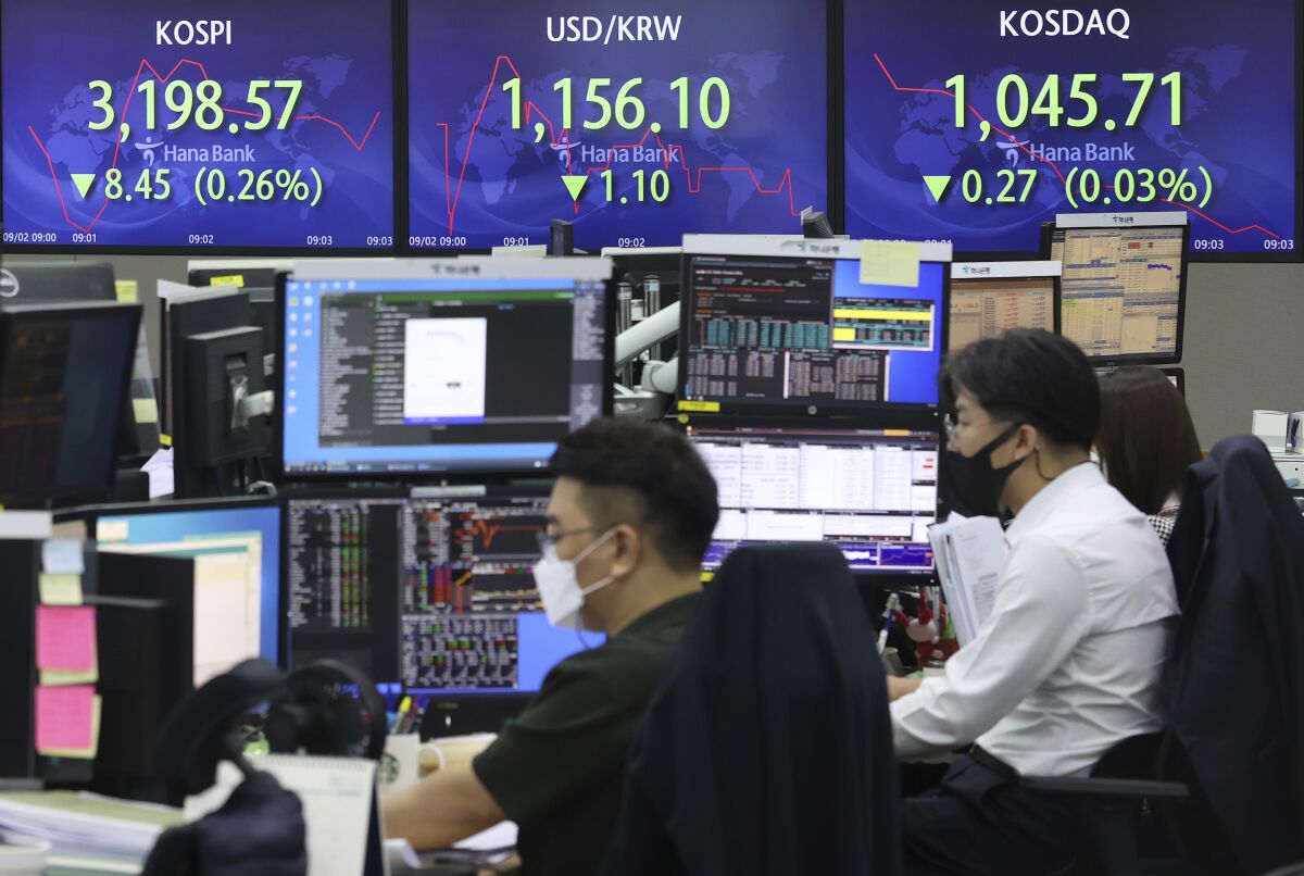 The screens show the Korea Composite Stock Price Index (KOSPI), left, and the foreign exchange rate between U.S. dollar and South Korean won, center, at the foreign exchange dealing room in Seoul, South Korea, Thursday, Sept. 2, 2021. Asian stocks rose Thursday as investors waited for U.S. jobs data that might influence when the Federal Reserve starts to wind down its stimulus. (Lee Ji-eun/Yonhap via AP)