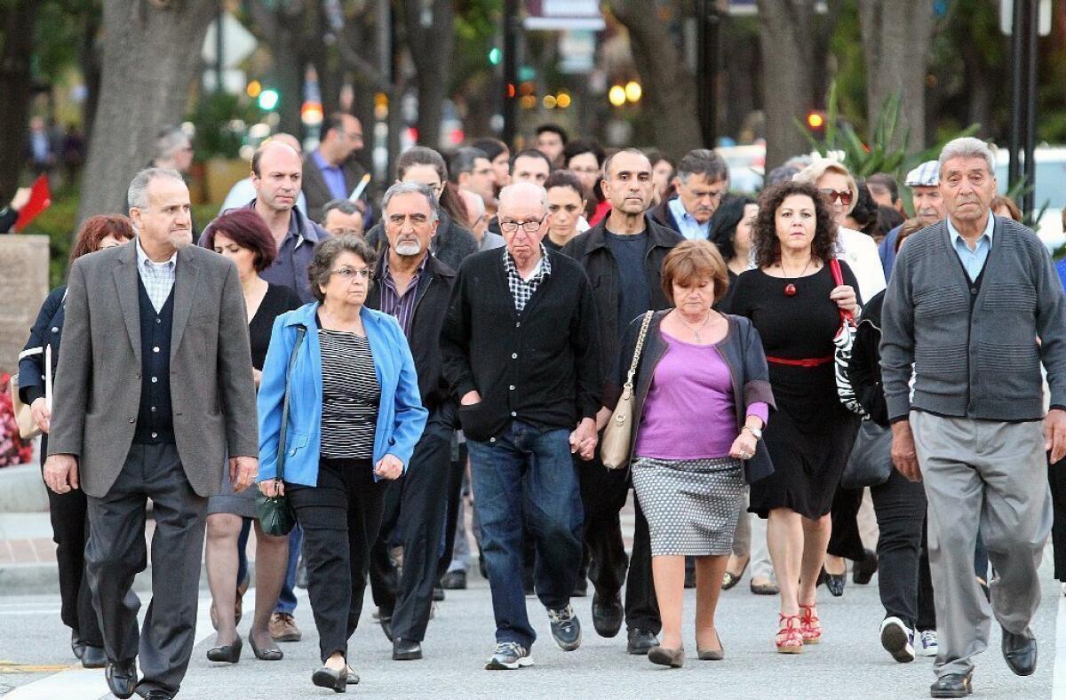 Armenian-Americans walk to commemorate the 99th anniversary of the Genocide in Burbank Tuesday evening.