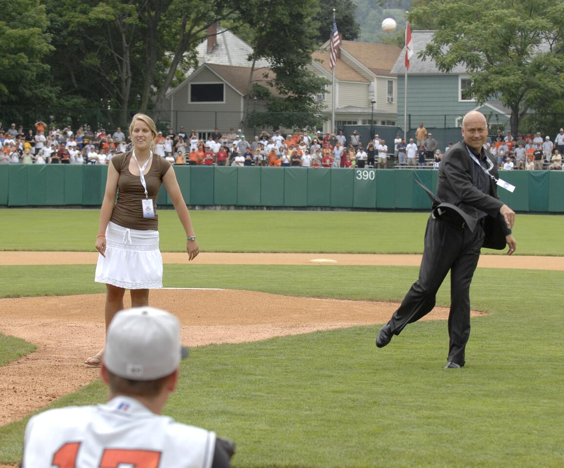 Cal Ripken Jr. throws out the ceremonial first pitch along with his daughter, Rachel (left), at the begining of the Aberdeen Ironbirds and the Oneonta Tigers New York-Penn League game held at Doubleday Field in Cooperstown, N.Y.