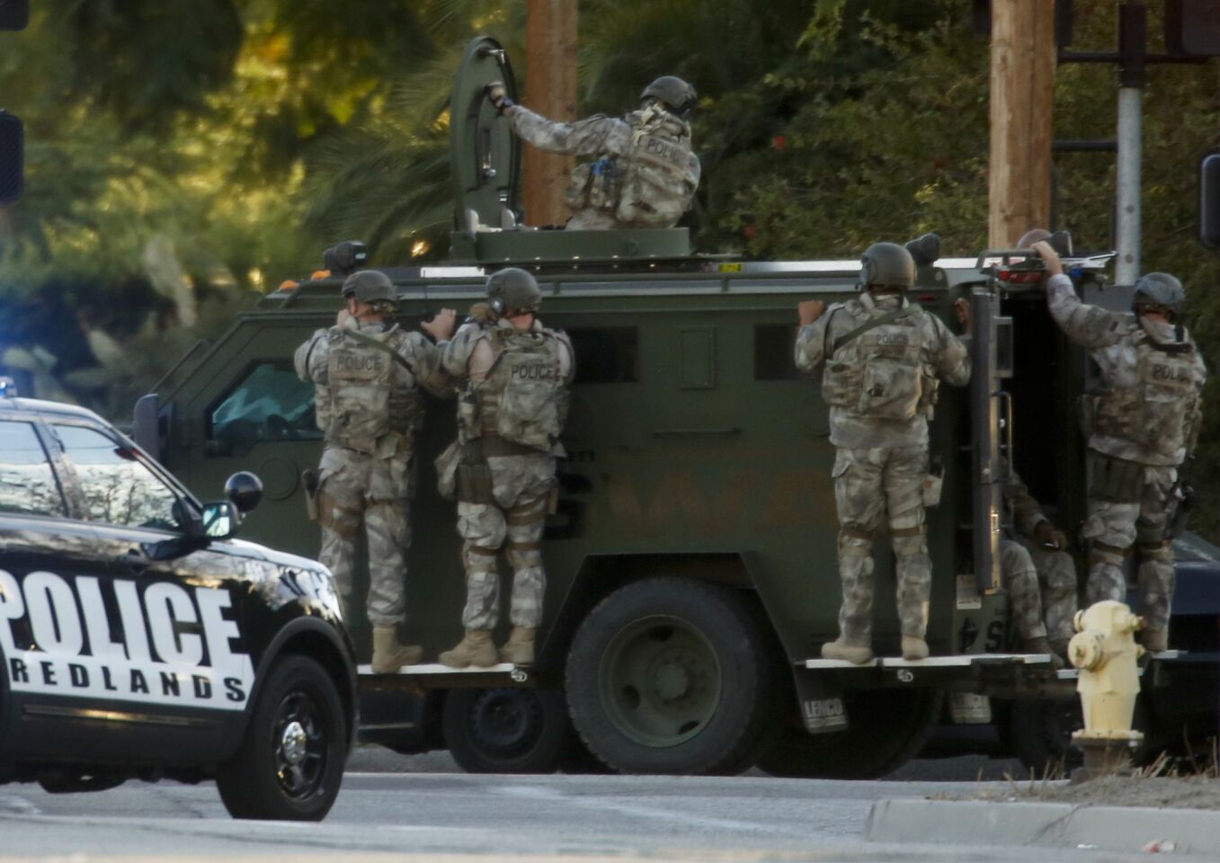 Sheriff's department SWAT members deploy near San Bernardino Avenue and Richardson Street in San Bernardino on Wednesday.