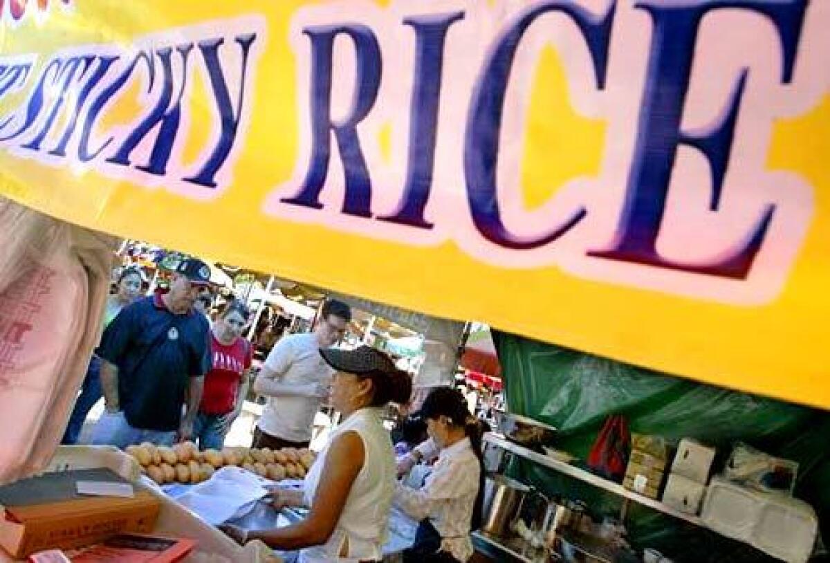 STICKY SITUATION: Patrons line up at a vendor at this weekend's Wat Thai Temple food fair.