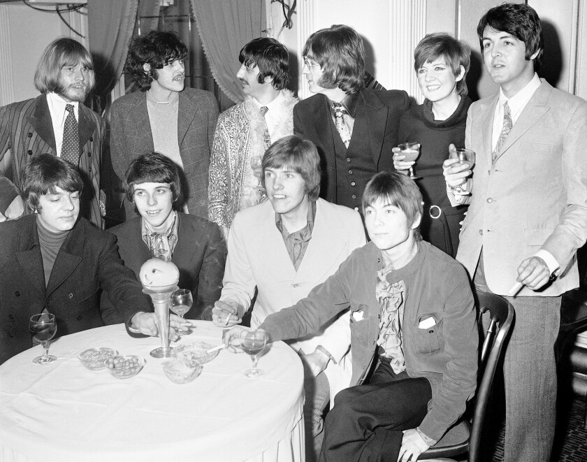 Cilla Black, standing, second from right, with members of the Beatles and members of the group Grapefruit, seated, at the launch of the Grapefruits' album "Dear Delilah" at London's Hanover Grand Hotel in January 1968.