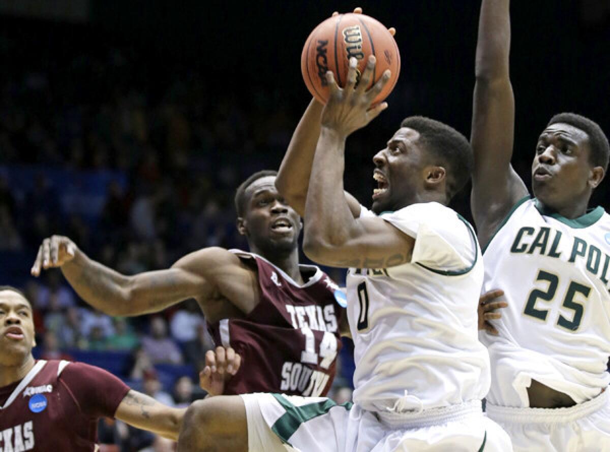 Cal Poly guard Dave Nwaba (0) drives to the basket against Texas Southern guard Ray Penn Jr. (14) in the first half Wednesday night in Dayton, Ohio.