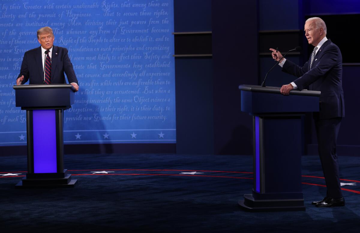 President Trump and former US Vice President Joe Biden speak during their first debate in Cleveland, Ohio, on Tuesday.