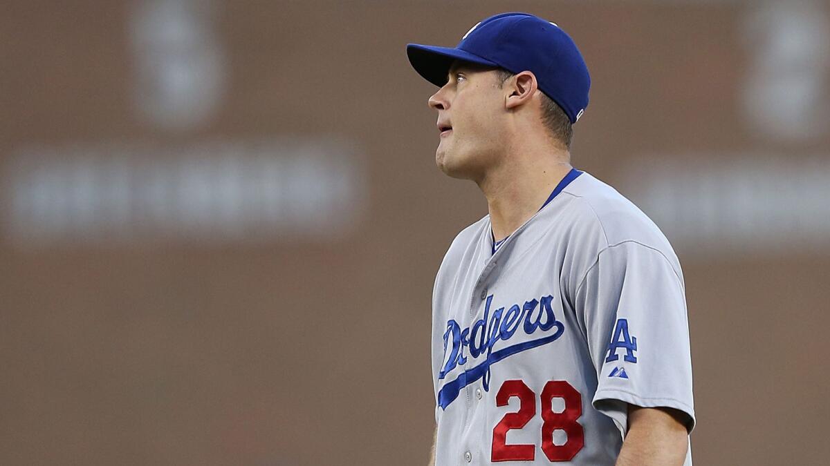 Dodgers reliever Jamey Wright reacts after walking Detroit's Alex Avila (not pictured) with the bases loaded in the fourth inning of the Dodgers' loss Tuesday.