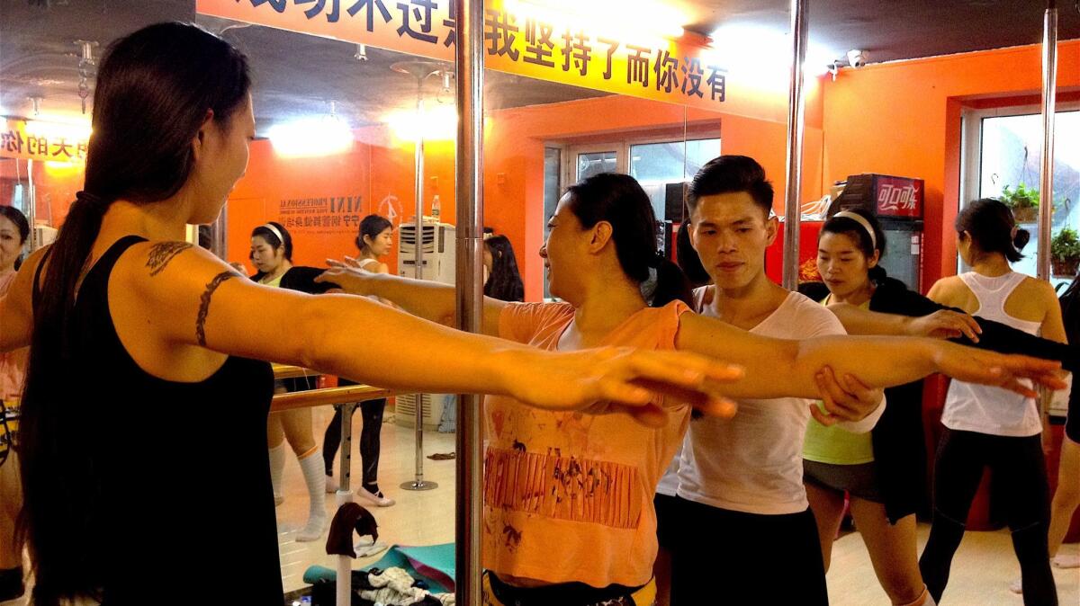 Hou Xing teaches a basic pole dancing technique course. (Yanan Wang / For The Times)