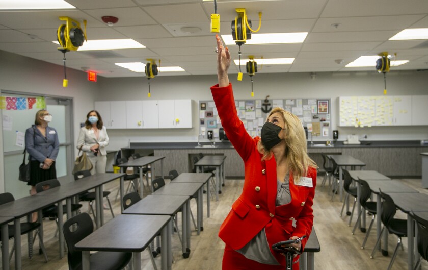 Ocean View School Board Trustee Gina Clayton-Tarvin takes a tour of a science room at Marine View Middle School.
