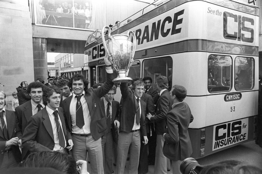 FILE - Nottingham Forest's Larry Lloyd, third left, and Ian Bowyer, third right, hold the European Cup, in Nottingham, England, May 31, 1979. Former Nottingham Forest and Liverpool defender Larry Lloyd has died at age 75. He was an England soccer international who was an integral part of Forest’s back-to-back European Cup-winning teams after capturing the English league title with Liverpool under Bill Shankly. Forest has announced the death of Lloyd on Thursday, March 28, 2024 without disclosing any further details. (PA via AP, File)