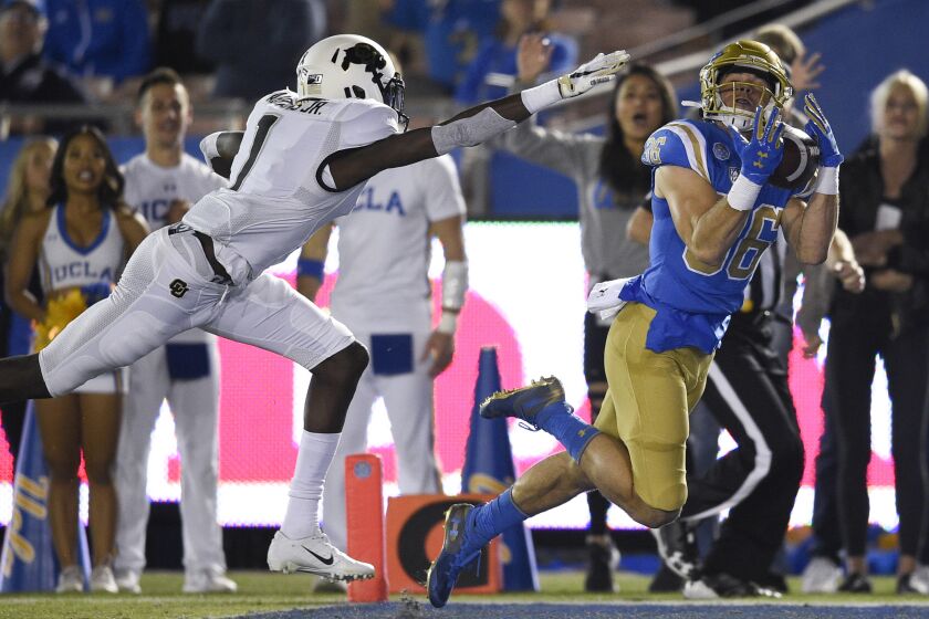 UCLA wide receiver Ethan Fernea, right, catches a pass for a touchdown past Colorado cornerback Delrick Abrams Jr. during the first half of an NCAA college football game in Los Angeles, Saturday, Nov. 2, 2019. (AP Photo/Kelvin Kuo)