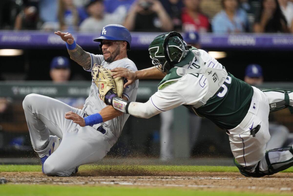 Colorado Rockies catcher Elias Diaz tags out Dodgers' David Peralta.