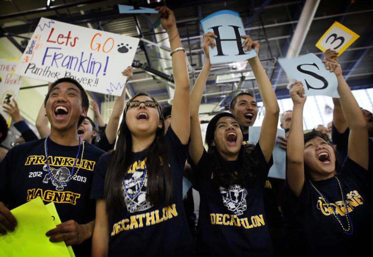 Franklin students Elijah Trinidad, left, Sabrina Velasco, Sandra Ruiz and Grace Punzalan cheer on their Academic Decathlon team during the Super Quiz at the regional decathlon competition in Los Angeles in February.
