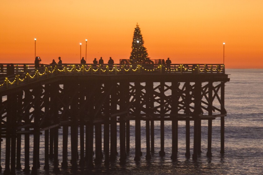 Crystal Pier in San Diego has it's annual Christmas light display with lights along the pier and a tree at the end.