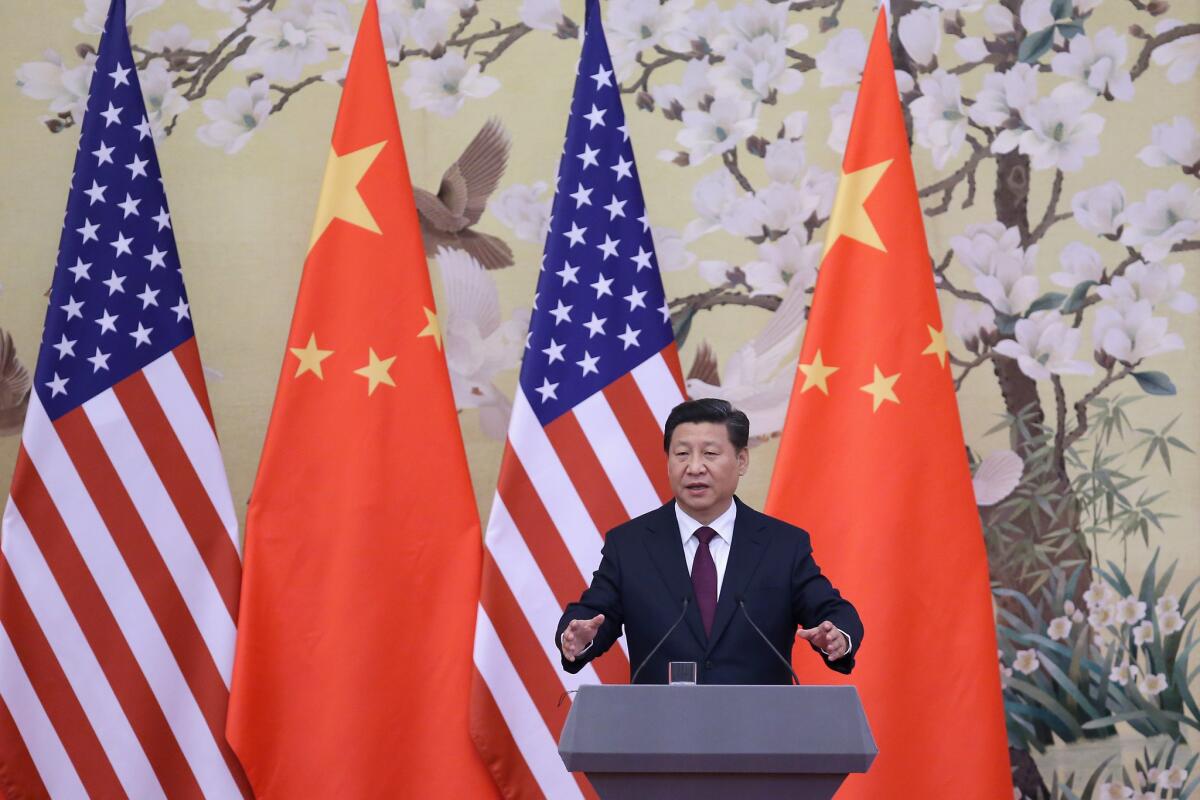 Chinese President Xi Jinping answers questions during a news conference with President Obama at the Great Hall of People in Beijing on Nov. 12.