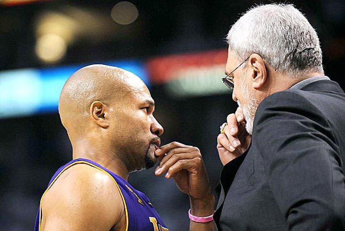 Point guard Derek Fisher and Coach Phil Jackson discuss strategy during Game 1 of the NBA Finals in 2008, which marked the return of the Lakers to championship-level basketball.