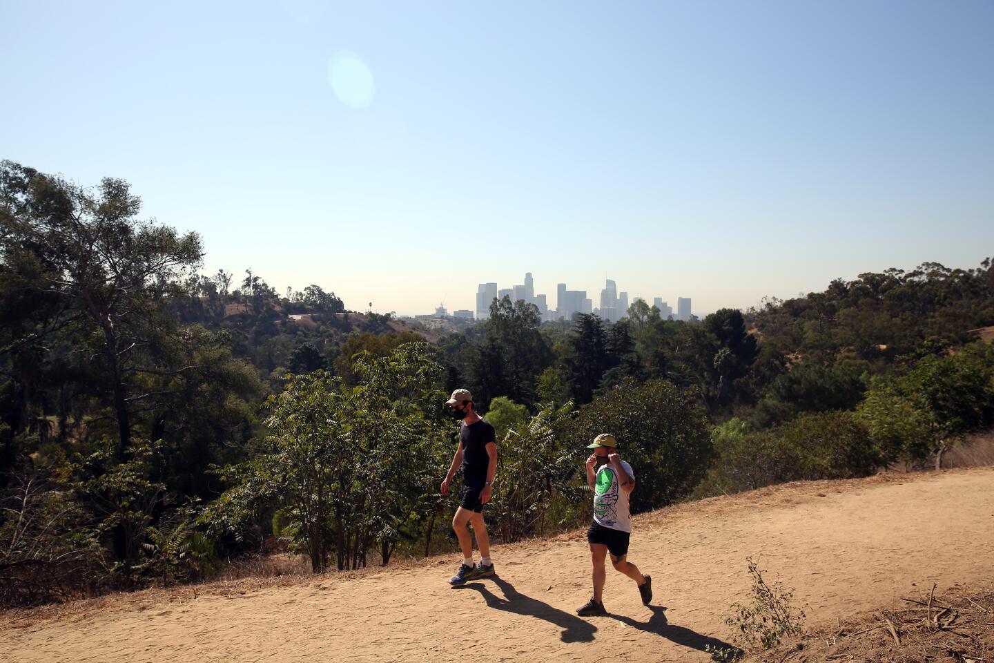 People walk in Elysian Park in Los Angeles on Tuesday.