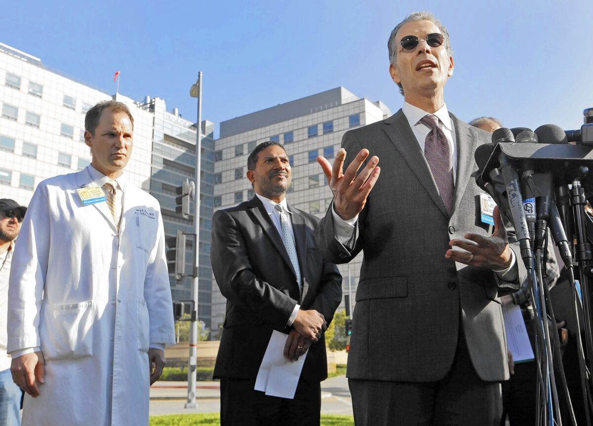 UCLA defended its new cleaning protocol and said no new infections have occurred since making the change. Above, Dr. David Feinberg, right, president of the UCLA Health System, takes questions during a press conference last week. With him are Dr. Zachary Rubin, left, UCLA's medical director of clinical epidemiology and infection prevention, and Robert Cherry, chief medical and quality officer at UCLA Health System