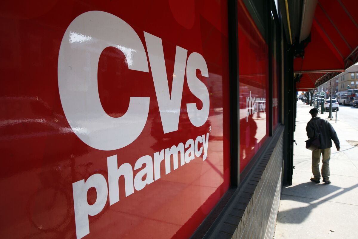 In this March 25, 2014, file photo, a CVS store is shown in Philadelphia. On Monday, Target announced that it is selling its pharmacy and clinic businesses to drugstore chain CVS Health for about $1.9 billion in a deal that combines the resources of two retailers seeking to polish their reputations as healthcare providers. (AP Photo/Matt Rourke, File)