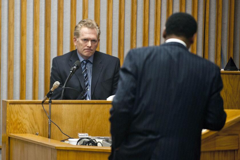 Film director Randall Miller, left, at the witness stand during a hearing before Chatham County Superior Court.
