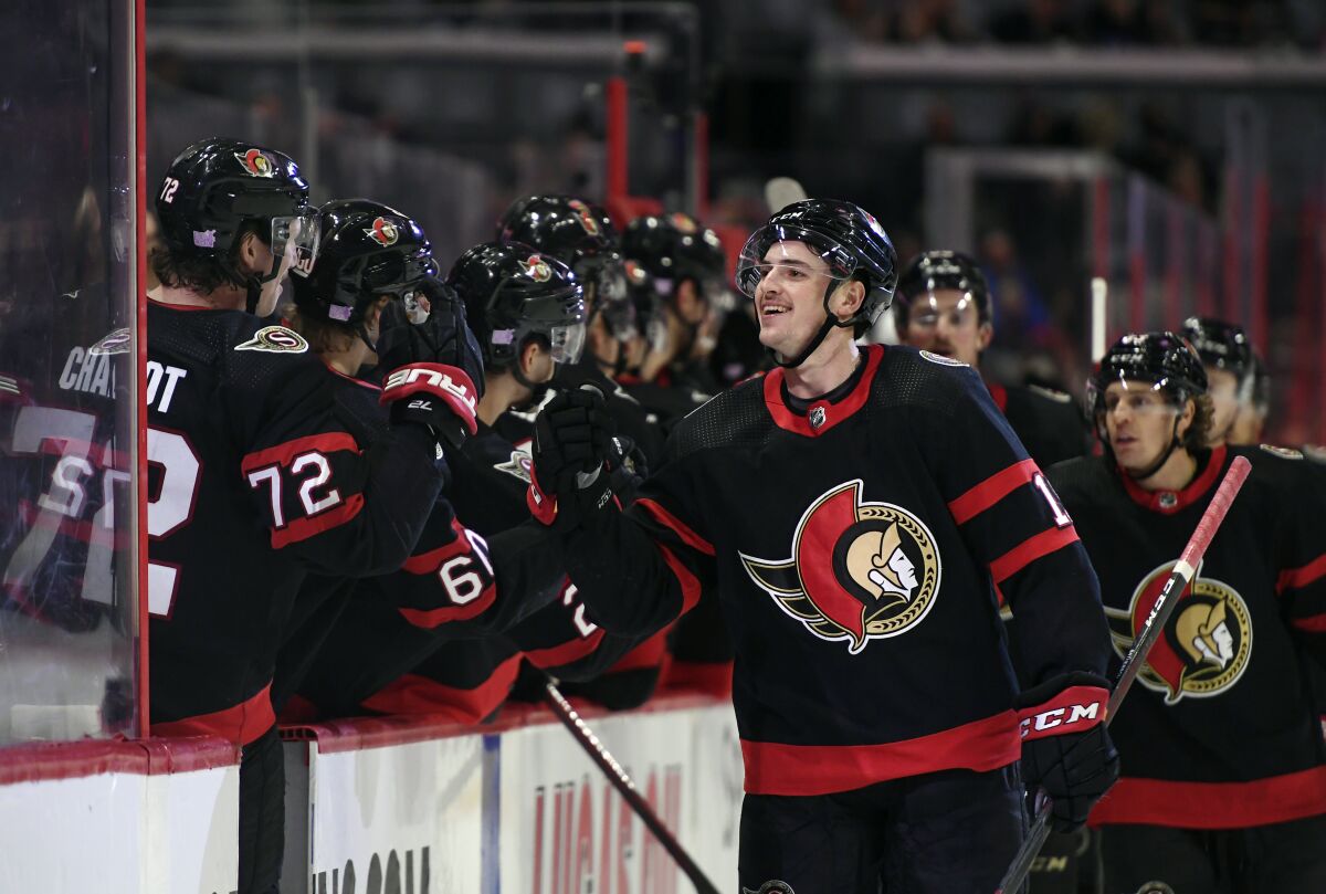 Ottawa Senators' Drake Batherson (19) celebrates with Thomas Chabot (72) after scoring against the Pittsburgh Penguins during the third period of an NHL hockey game in Ottawa, on Saturday, Nov. 13, 2021. (Justin Tang/The Canadian Press via AP)