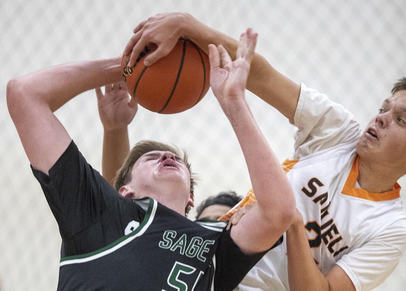 Sage Hill School's Johnny King has his shot blocked by Samueli Academy's Grant Wempner in a nonleague game at the American Sports Centers complex in Anaheim on Wednesday, November 14.