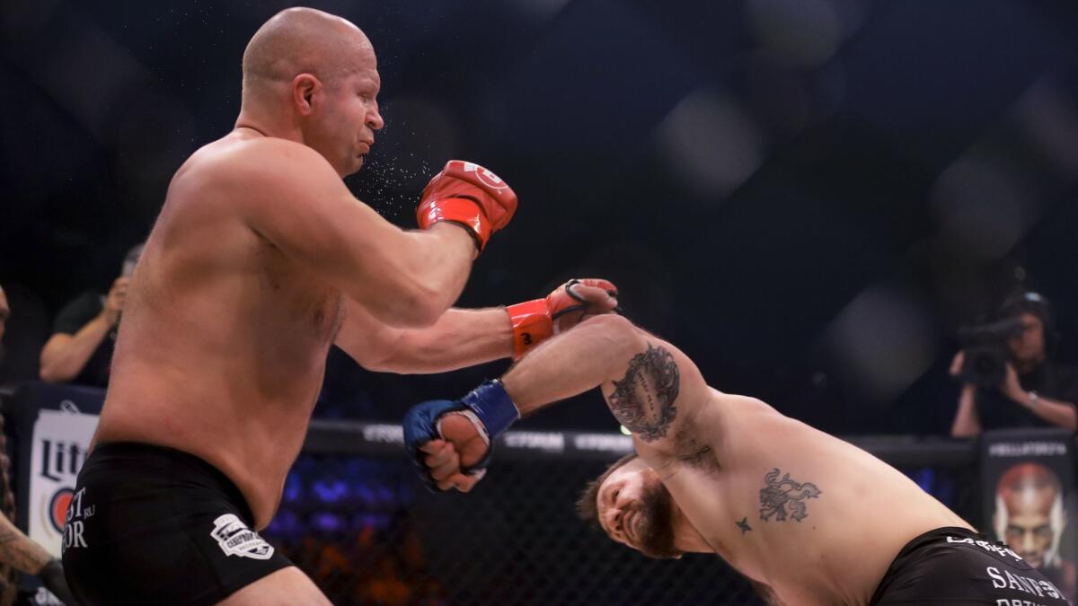 Ryan Bader, right, knocks out Fedora Emelianenko after flooring him with a left to the face during their bout at Bellator 214.