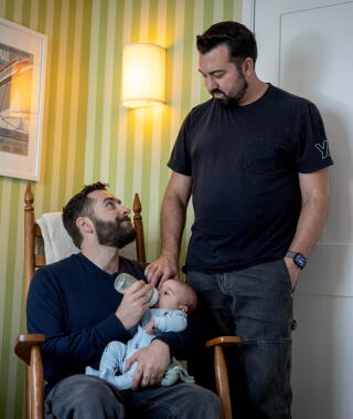 David Vulin, left, feeds his son with his husband, Anthony Vulin, right, at their West Hollywood home.
