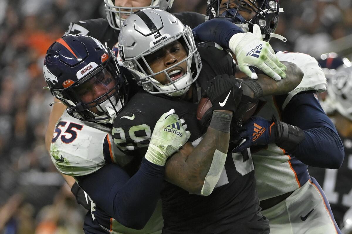 Denver Broncos outside linebacker Bradley Chubb tackles Las Vegas Raiders running back Josh Jacobs during the second half.