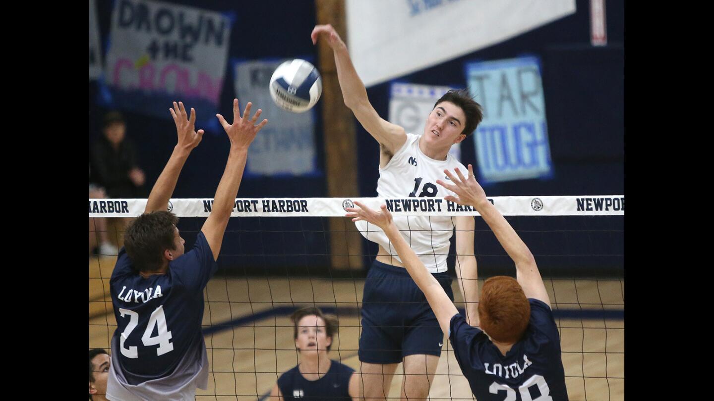 Newport Harbor High's Ethan Talley kills a ball after a quick set during volleyball semifinals in the CIF Southern California Regional Division I playoffs against Loyola on Thursday.