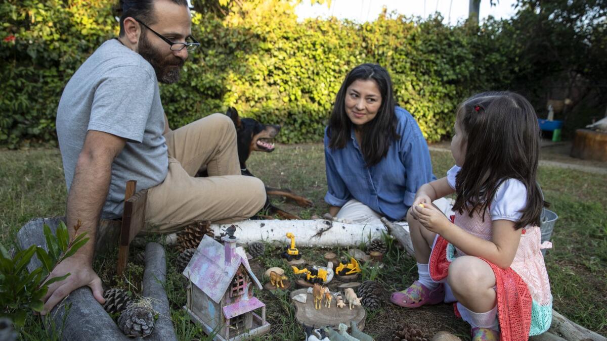 Los Angeles Times reporter Esmeralda Bermudez at home in the garden with her husband David and 5-year-old daughter on June 7, 2018.