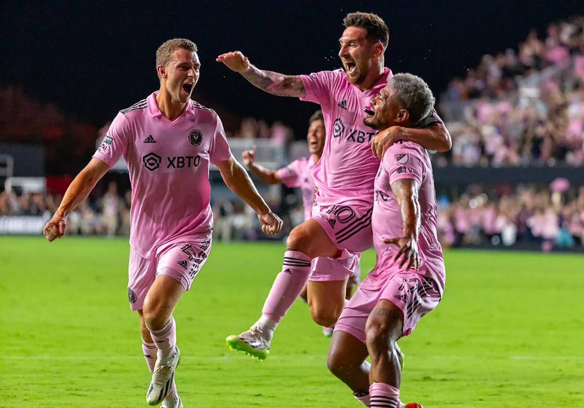 Inter Miami's Lionel Messi celebrates with teammates DeAndre Yedlin and Christopher McVey.