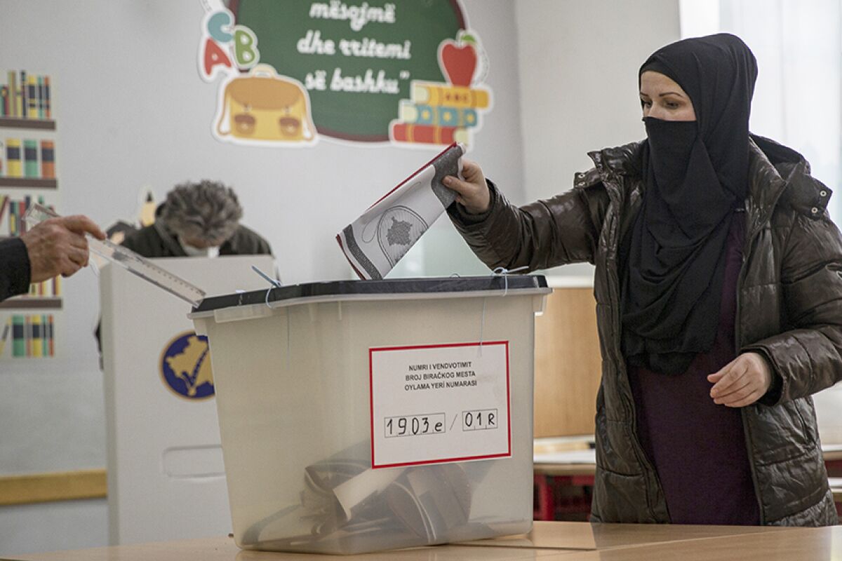 A woman casts her ballot in Pristina, Kosovo, on Sunday.