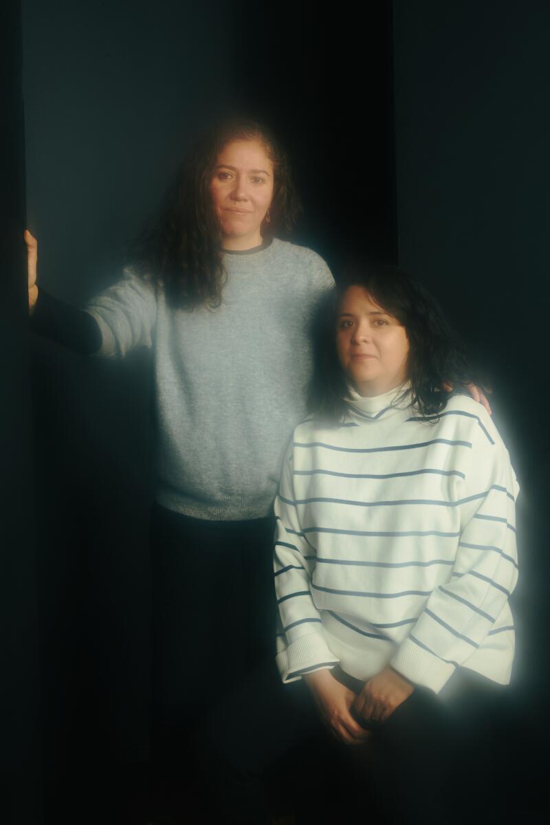 Two people pose for a portrait