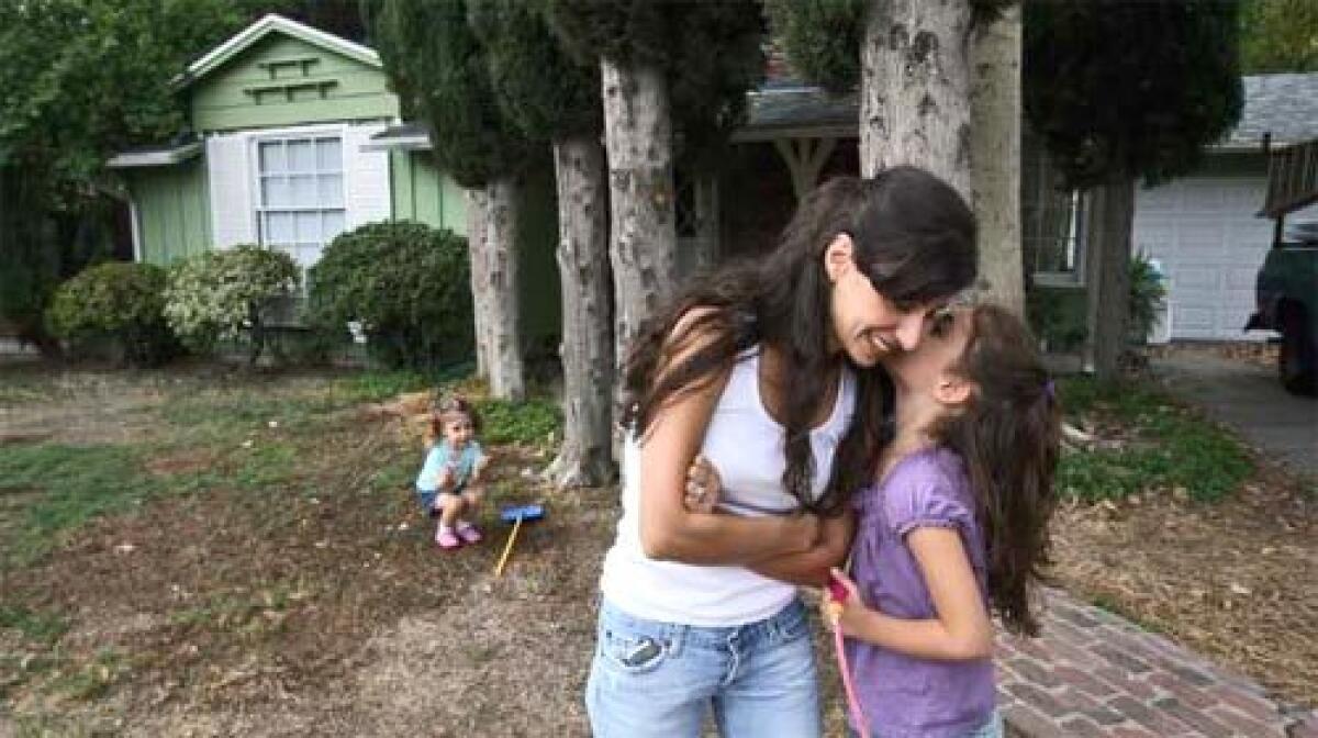 AT HOME: Hedy Maar and daughters Leylah, left, and Sarah. A first-time-buyer program helped the Maars to buy their $479,950 Granada Hills home.