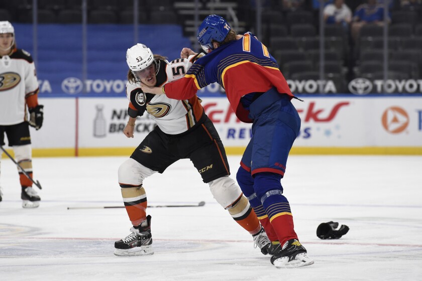 Anaheim Ducks' Max Comtois (53) gets physical with St. Louis Blues' Niko Mikkola (77) during the first period of an NHL hockey game on Wednesday, May 5, 2021, in St. Louis. (AP Photo/Joe Puetz)