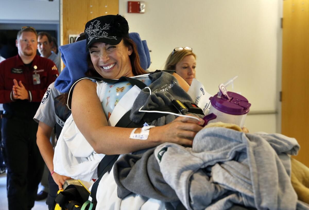 Amy Van Dyken-Rouen is taken to her room after arriving at Craig Hospital in Englewood, Colo., on Wednesday.